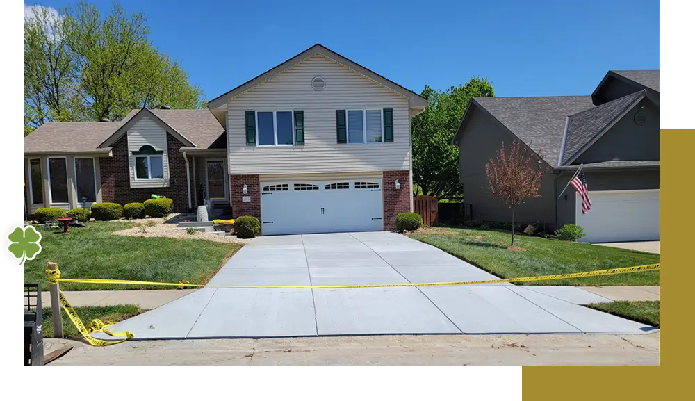 A house with two cars parked in front of it.